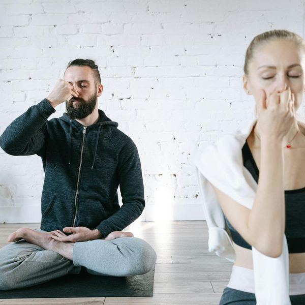 Person meditating in a bright, calm room.